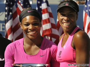Serena (left) and Venus celebrate winning their third grand slam title of the year in New York.