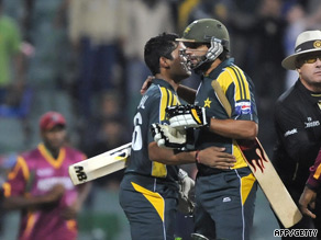 Afridi and Akmal embrace after seeing Pakistan home by five wickets.