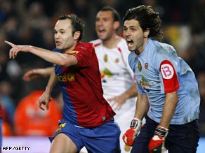 Iniesta (left) celebrates his important goal for Barcelona as Lux protests.