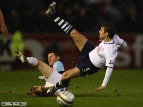 Tottenham winger David Bentley (right) is sent flying as the Carling Cup holders scraped into the final again.