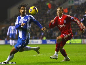 Mido (left) scored a vital equalizer on his Wigan debut to dent Liverpool's Premier League title challenge.