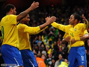 Robinho, right, is congratulated by Brazil team-mates after his magic unhinged Italy in the prestige friendly.