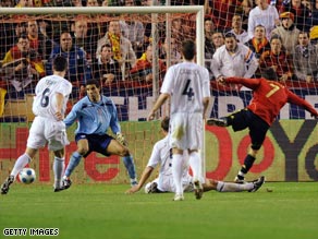 David Villa (far right) scores the opening goal in Spain's 2-0 victory over England in Seville.