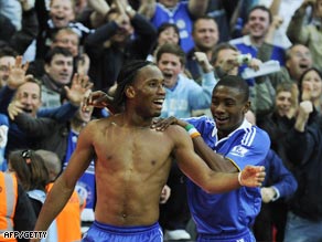 A bare-chested Drogba is congratulated by Salomon Kalou after scoring the winner at Wembley.