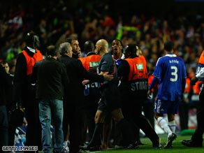 Didier Drogba confronts referee Tom Henning after Chelsea's dramatic Champions League exit.