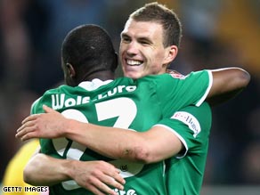 Two-goal Dzeko, facing, celebrates with Grafite who was also on target for Bundesliga leaders Wolfsburg.