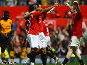 United players celebrate after securing the draw that gave them a third successive Premier League title.