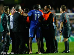 Drogba is held back by stewards at the end of Chelsea's controversial Champions League exit.