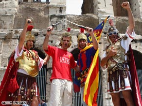 United and Barcelona fans, dressed as centurions, pose together outside Rome's Colosseum.