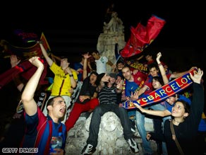 Barcelona fans celebrate in the city's Las Ramblas thoroughfare early Thursday morning.