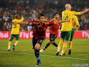 The South African players appeal for handball as David Villa celebrates Spain's opening goal on Saturday.