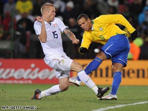 Luis Fabiano turns and shoots past U.S. defender Jay DeMerit to score his first goal of the final.