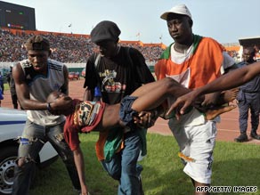 A young fan is carried away following the crush that saw 22 supporters lose their lives in Abidjan in March.