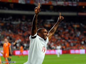 Defoe celebrates his opening goal for England in Amsterdam.