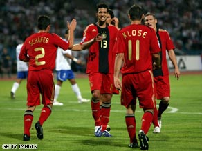 Germany celebrate Klose's goal in Baku which confirmed their victory.
