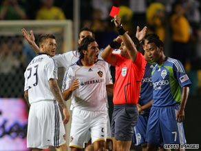 David Beckham (left) is shown a straight red card for his tackle on Seattle Sounders star Peter Vagenas.
