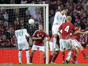 Liedson (no 9) heads home Portugal's late equalizer in Copenhagen against the Danes.