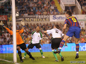 Zlatan Ibrahimovic rises to head home Barcelona's opening goal against Racing Santander.