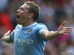 Craig Bellamy scored twice as Manchester City suffered a heartbreaking 4-3 defeat at Old Trafford.