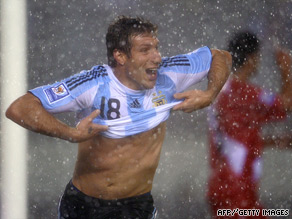 Palermo celebrates his dramatic last-gasp goal to give Argentina a vital 2-1 victory over Peru.