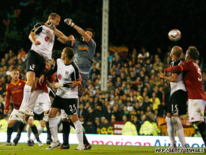 Fulham center-back Brede Hangeland rises highest to head home against Italian club Roma.