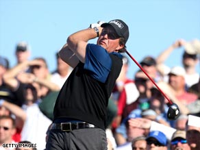 Mickielson tees off on the 11th watched by a big gallery at the TPC of Scottsdale.