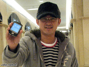Shi Rui Huan, aka, 'the 3G guy' shows off his 3G phone. Will millions of other Chinese follow his lead?