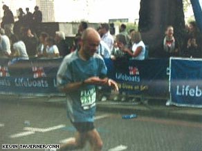 A blurry Pete Wilkinson texts from his cellphone as he runs in Sunday's London Marathon.