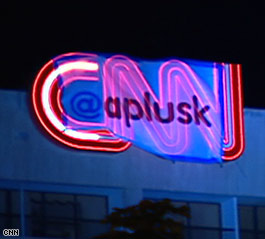 A banner with Ashton Kutcher's Twitter name, aplusk, was unfurled Wednesday over the CNN logo at CNN Center.
