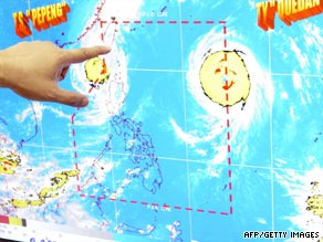 A Philippines scientist points to a screen monitoring Tropical Storm Parma and Typhoon Melor.