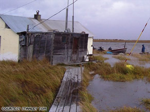 Floodwaters rip through the village of Newtok, Alaska, destroying its infrastructure.