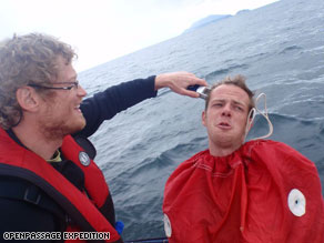 High seas high jinx: Tobias gives his shipmate Hanns a haircut at sea using a sail bag as a barber cape.