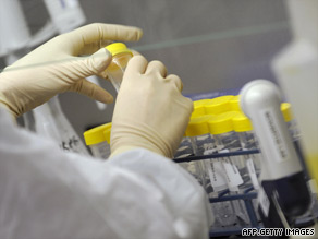 A scientist examines samples from suspected swine flu patients at a WHO laboratory in Melbourne, Australia.