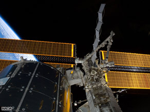 The solar panels installed to the space station are seen Thursday with Earth in the backdrop.