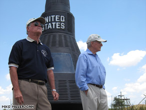 Astronauts Bob Crippen, left, and Scott Carpenter beside a space capsule at a Florida chimpanzee sanctuary.