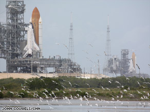 Space shuttle Endeavour, in background, sits poised to launch in case Atlantis, in foreground, meets trouble.