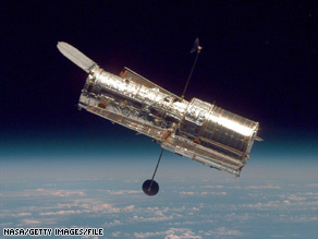 The Hubble Space Telescope hangs above Earth in a 1997 photo taken from the shuttle Discovery.