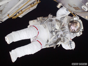 Flight engineer Nicole Stott removes a depleted ammonia tank from the international space station.