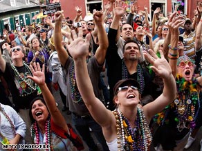 A crowd of people try to catch beads on Bourbon Street on Fat Tuesday last year.