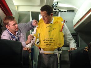 CNN's Richard Quest tries on a lifejacket at the British Airways Flight Training Centre.