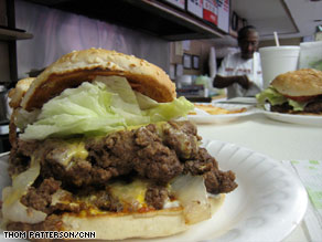 Ann Price works behind the counter after serving a "Ghetto Burger," which was dubbed America's best.
