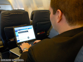 An American Airlines passenger uses Wi-Fi to access the Internet during a flight.