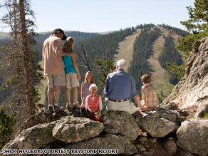 A family takes a break on a hike at Keystone Resort in Colorado.
