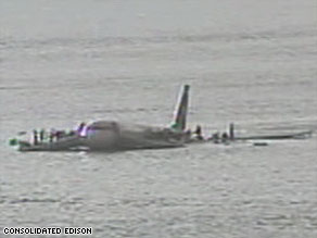Surveillance video shows passengers of US Airways Flight 1549 hurrying onto the plane's wings.