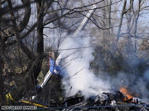 Smoke rises from the tail section of the Continental turboprop at the crash site near Buffalo on Friday.