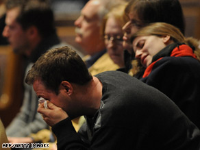A man wipes away tears during a community memorial service Friday at a church near Buffalo, New York.
