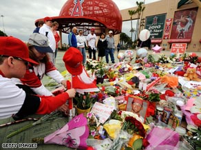 Fans gather around a memorial for Los Angeles Angels pitcher Nick Adenhart on Friday.