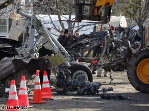 Debris is cleared from the scene of Flight 3407's crash near Buffalo, New York, in February.