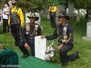 A color guard folds the American flag as Mays is saluted when three rifle volleys pierced the air.