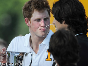 Prince Harry playfully spits champagne to Nacho Figueras (R) after polo match Saturday at Governors Island.